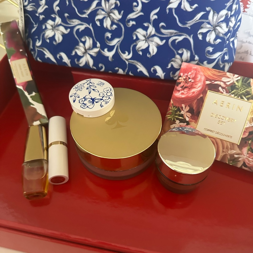 AERIN makeup bag full of goodies including Lipstick gloss compact & more